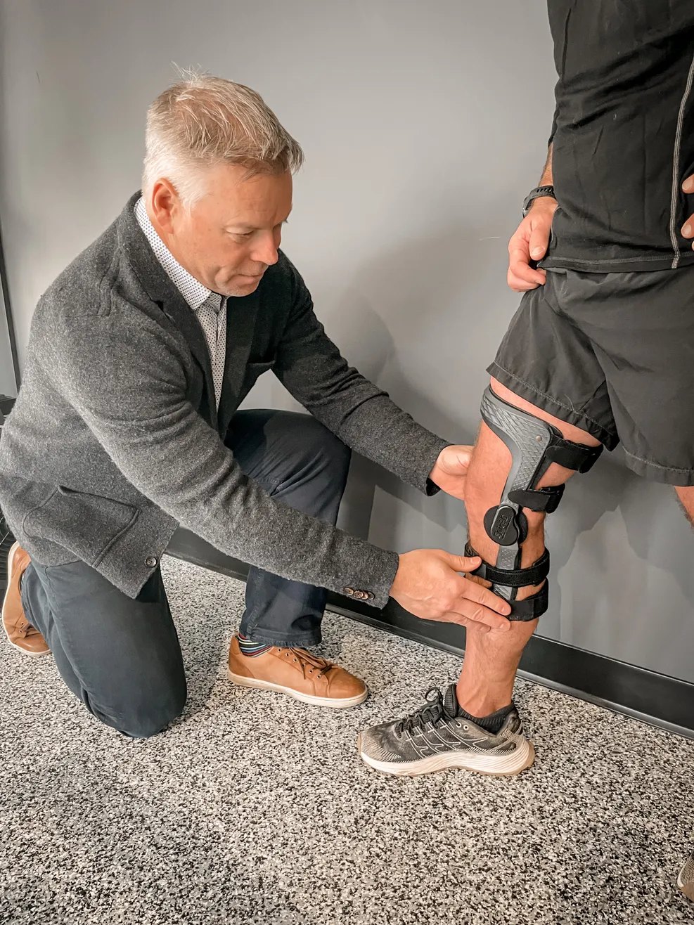 Steve fitting a custom knee brace during an in-person assessment